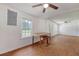 Bright living room showcasing a ceiling fan, window, and unfinished walls and hardwood floors at 2202 Sc-61, Ridgeville, SC 29472