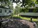 View of a backyard with some gravel, two small outbuildings, and sparse landscaping at 2204 Dover St, North Charleston, SC 29405