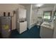 Functional bathroom with a stacked washer/dryer, vanity, shower, and linen storage at 2204 Dover St, North Charleston, SC 29405