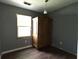 Cozy bedroom featuring a wardrobe, neutral walls, a window for natural light, and hard wood floors at 2204 Dover St, North Charleston, SC 29405