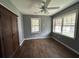 Bright bedroom with a wardrobe, ceiling fan, and multiple windows offering ample natural light and hard wood floors at 2204 Dover St, North Charleston, SC 29405