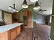 Spacious kitchen with an island, wood cabinets, unique lighting fixtures, and hard wood floors at 2204 Dover St, North Charleston, SC 29405