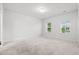 Bright bedroom with neutral carpet, two windows, and a smooth white wall at 226 Clydesdale Cir, Summerville, SC 29486