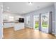 Open kitchen with white cabinets, black appliances, granite countertops and sliding door access to the backyard at 226 Clydesdale Cir, Summerville, SC 29486