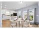 Staged kitchen and dining area with white cabinets, granite counters, black appliances and patio access at 226 Clydesdale Cir, Summerville, SC 29486