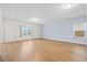 Spacious living room features light wood floors, neutral paint, large windows, and modern recessed lighting at 226 Clydesdale Cir, Summerville, SC 29486