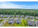 Wide aerial shot showcasing a neighborhood with pond views, tree lined streets, and well-maintained landscaping at 2336 Brinkley Rd, Johns Island, SC 29455