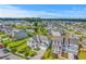 Aerial view of a community with well-maintained homes, lush landscaping, and a tranquil pond at 2336 Brinkley Rd, Johns Island, SC 29455