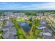 An aerial view highlighting a residential community with a lake, manicured lawns, and green landscaping at 2336 Brinkley Rd, Johns Island, SC 29455