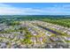 Aerial view showcasing a large residential community with lush green spaces and a tranquil lake at 2336 Brinkley Rd, Johns Island, SC 29455