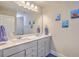 Bathroom featuring double sinks, framed mirror and three fun cartoon ocean themed pictures at 2336 Brinkley Rd, Johns Island, SC 29455