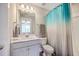 Well-lit bathroom featuring a vanity with a large mirror and a blue shower curtain at 2336 Brinkley Rd, Johns Island, SC 29455