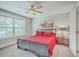 Comfortable bedroom with red comforter, ceiling fan, and window with lots of natural light at 2336 Brinkley Rd, Johns Island, SC 29455