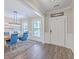 Elegant dining room featuring a wooden table, blue chairs, and modern light fixture at 2336 Brinkley Rd, Johns Island, SC 29455