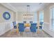 Charming dining area with a wooden table, blue upholstered chairs, and stylish light fixture at 2336 Brinkley Rd, Johns Island, SC 29455
