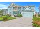 Attractive two-story home with a balcony, a blue garage door, well-maintained lawn, and a paved driveway at 2336 Brinkley Rd, Johns Island, SC 29455