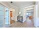 Hallway with wood floors, neutral walls, cabinet, and open doorways leading to the bathroom and living room at 2336 Brinkley Rd, Johns Island, SC 29455