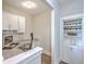 Well-lit home office with built-in desk, cabinetry, and shelving, including a wine rack and space for storage at 2336 Brinkley Rd, Johns Island, SC 29455