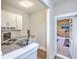 Well-lit home office with built-in desk, cabinets, and access to adjacent home gym, perfect for work and fitness at 2336 Brinkley Rd, Johns Island, SC 29455