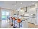 Modern kitchen with white cabinetry, stainless steel appliances, large island with bar seating, and light wood floors at 2336 Brinkley Rd, Johns Island, SC 29455