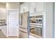 Kitchen with stainless steel refrigerator and oven appliances, along with white cabinets and trim at 2336 Brinkley Rd, Johns Island, SC 29455