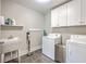 Well-equipped laundry room with washer, dryer, sink, and ample storage space at 2336 Brinkley Rd, Johns Island, SC 29455