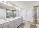 Main bathroom with double sinks, a large mirror, and tiled walls at 2336 Brinkley Rd, Johns Island, SC 29455