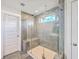Modern tiled shower with a glass door, convenient bench seating, and bright natural light at 2336 Brinkley Rd, Johns Island, SC 29455