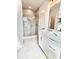 Bright bathroom featuring a glass shower, white cabinets, and tile floors at 25 Nats Ct, Charleston, SC 29403