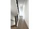 Hallway with wood floors and stairs with wrought iron railing at 25 Nats Ct, Charleston, SC 29403