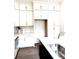 Modern kitchen with white cabinets, stainless steel appliances, and a dark blue island at 25 Nats Ct, Charleston, SC 29403