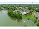 A scenic aerial view showcasing a community pool and playground beside a serene lake with lush landscaping at 251 Emerald Isle Dr, Moncks Corner, SC 29461