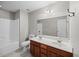 Bathroom with double sink vanity, large mirror, and shower-tub combo at 251 Emerald Isle Dr, Moncks Corner, SC 29461