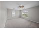 Bright bedroom featuring neutral walls, ceiling fan, carpet floors, and large windows at 251 Emerald Isle Dr, Moncks Corner, SC 29461