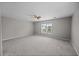 Spacious, carpeted bedroom with a ceiling fan, window, and natural light at 251 Emerald Isle Dr, Moncks Corner, SC 29461
