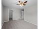 Bedroom featuring neutral walls, ceiling fan, carpet floors, and open closet at 251 Emerald Isle Dr, Moncks Corner, SC 29461