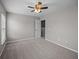 Bright bedroom with neutral walls, ceiling fan, carpet, and open closet at 251 Emerald Isle Dr, Moncks Corner, SC 29461