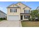 Charming two-story home featuring a classic design, attached garage and manicured landscaping at 251 Emerald Isle Dr, Moncks Corner, SC 29461