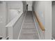 Carpeted staircase with wooden handrail leading to the upper level of the home at 251 Emerald Isle Dr, Moncks Corner, SC 29461