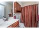 Cozy bathroom with cherry colored vanity, neutral walls, and shower with curtain at 254 Mayfield Dr, Goose Creek, SC 29445