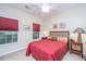 Inviting bedroom with neutral walls, lots of natural light, and red window treatments at 254 Mayfield Dr, Goose Creek, SC 29445
