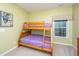 Comfortable bedroom featuring a wooden bunk bed and a window with a view to the backyard at 254 Mayfield Dr, Goose Creek, SC 29445