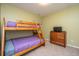 Cozy bedroom features a wooden bunk bed, a dresser, and a light green painted wall at 254 Mayfield Dr, Goose Creek, SC 29445
