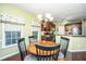Bright dining area adjacent to the kitchen with wood floors and a chandelier at 254 Mayfield Dr, Goose Creek, SC 29445