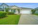 A cozy single-story house with a green lawn and an attached garage, ideal for a small Gathering or downsizing at 254 Mayfield Dr, Goose Creek, SC 29445