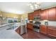 Well-lit kitchen with stainless steel appliances, granite countertops, and dark wood cabinets at 254 Mayfield Dr, Goose Creek, SC 29445