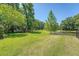 Lush backyard featuring well-maintained green grass, mature trees, and a serene pond area at 2701 Fountainhead Way, Mount Pleasant, SC 29466