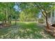 Expansive backyard featuring lush green grass, mature trees, and ample space for outdoor activities at 2701 Fountainhead Way, Mount Pleasant, SC 29466