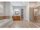 Bright bathroom featuring a soaking tub, double vanity, walk-in shower, and walk-in closet at 2701 Fountainhead Way, Mount Pleasant, SC 29466