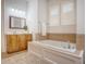 Bright bathroom featuring a soaking tub and double vanity with a large framed mirror at 2701 Fountainhead Way, Mount Pleasant, SC 29466